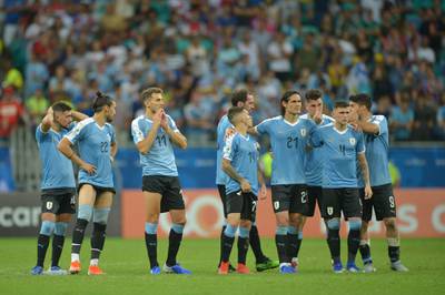 Uruguay players watch on during the penalty shootout against Peru. AFP