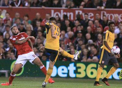 Arsenal’s Granit Xhaka, second left, shoots to score the opening goal. Lindsey Parnaby / AFP