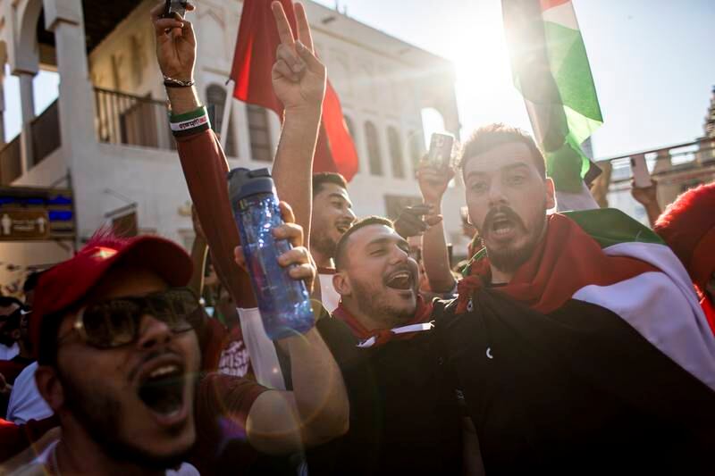 Fans of Morocco wave flags of Morocco and Palestine at the Souq Waqif market during FIFA World Cup 2022 in Doha, Qatar, 14 December 2022.  Morocco will face France in their FIFA World Cup 2022 semi final soccer match on 14 December 2022.   EPA / MARTIN DIVISEK