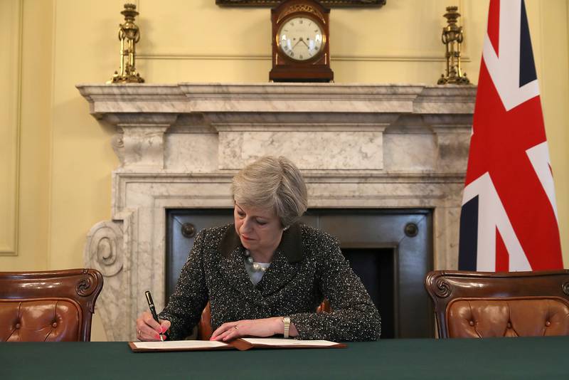 British prime minister Theresa May signs the official letter to launch Brexit. Christopher Furlong / Reuters

