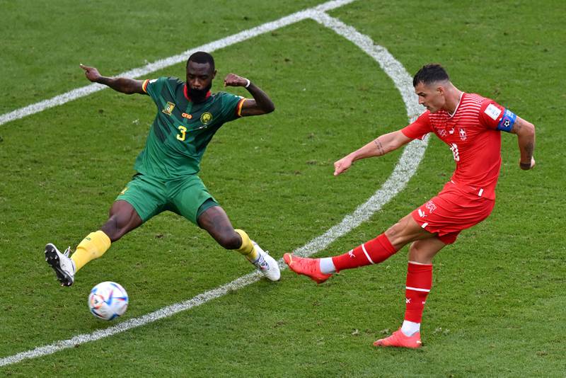 Cameroon defender Nicolas Nkoulou attempts to block a shot by Granit Xhaka of Switzerland. AFP
