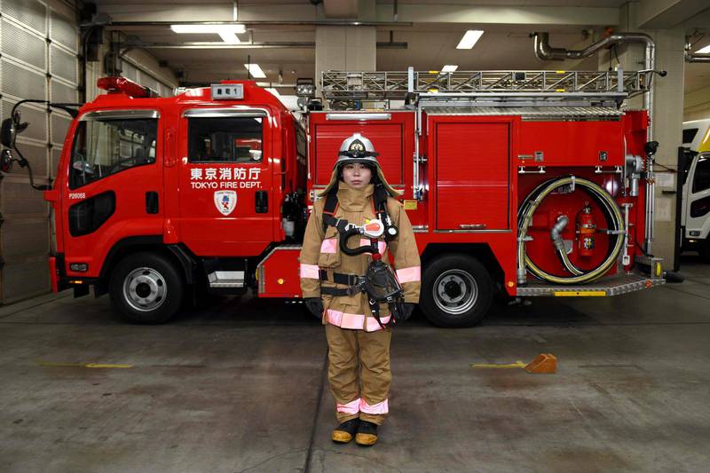 Ran Namise, a firefighter belonging to a command squad in Tokyo, poses in front of a fire engine at Kojimachi Fire Station. Kazuhiro Nogi / AFP Photo