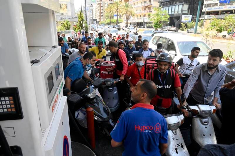 Motorists crowd at a gas station trying to get fuel for their vehicles as supplies are rationed in Beirut.