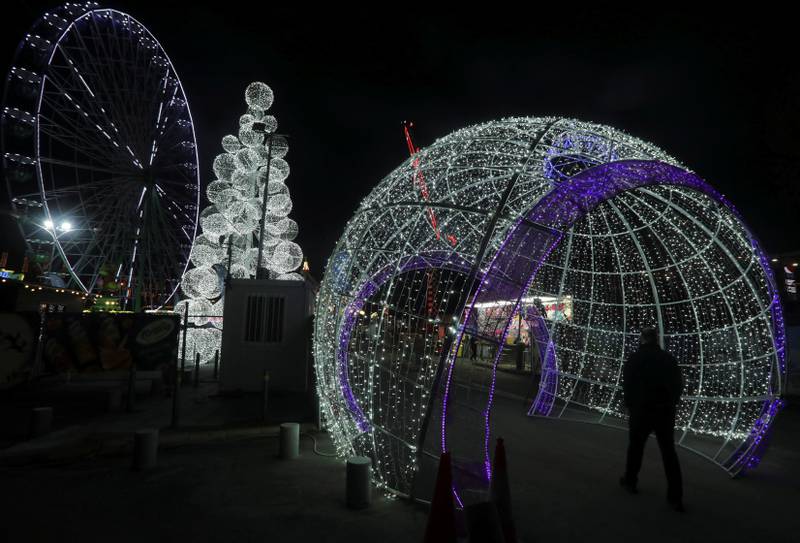 A man walks through a giant illuminated Christmas sphere in the Christmas Lunapark in Nicosia, Cyprus. Reuters