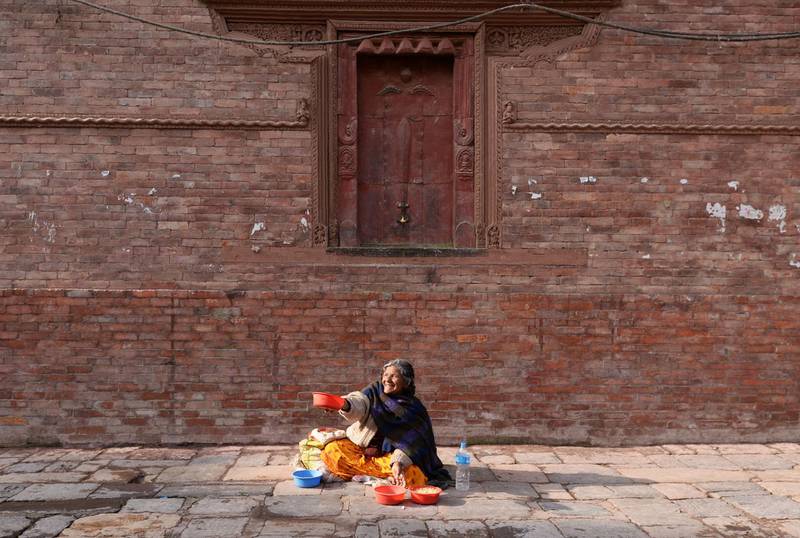A Nepali street vendor sells grain to feed pigeons at Basantapur Durbar Square in Kathmandu. AFP