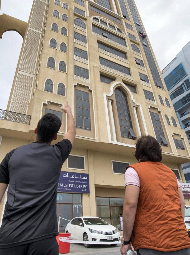 RAS ALKHAIMAH, UNITED ARAB EMIRATES - People staying at the building pointing pointing at the floor where a girl fell from the 10 floor of the building.  Leslie Pableo for The National for Ruba Haza's story