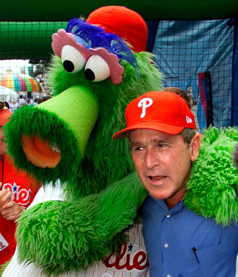 In this July 4, 2001 photo, President George W Bush celebrates the Fourth of July holiday in Philadelphia and poses with that city's baseball mascot, the Philly Phanatic. AP Photo