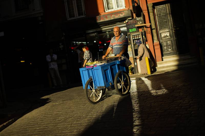A street food vendor pushes his trolley in Istanbul. Government data showed that Turkey's annual inflation was up at almost 80 per cent in July, which was a 24-year high. AP