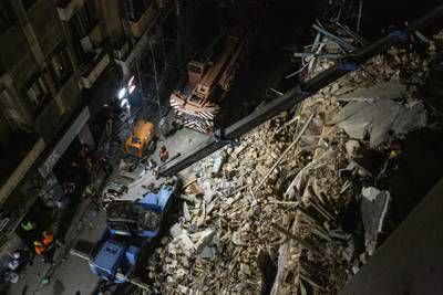 Rescue workers use a crane to lift concrete slabs from a destroyed building as they search for survivors in Beirut, Lebanon. A sniffer dog with a Chilean rescue crew responded to the presence of a person in the rubble of a building damaged in the deadly explosion on August 4. The condition of the person is unknown. Getty Images