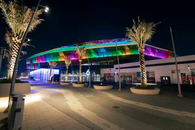 Etihad Arena on Yas Island, lit up for Holi.