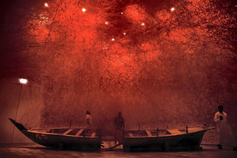 People take a look at the "Departure" installation by Japanese artist Chiharu Shiota at the Jameel Arts Centre in Dubai, United Arab Emirates, Friday, April 26, 2019. (Shruti Jain/The National)