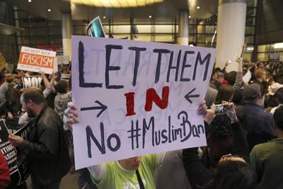 People opposed to president Donald Trump's executive order barring entry to the US by Muslims from certain countries demonstrate at the Tom Bradley International Terminal at Los Angeles International Airport on Saturday, January 28, 2017, in Los Angeles. Reed Saxon / AP Photo