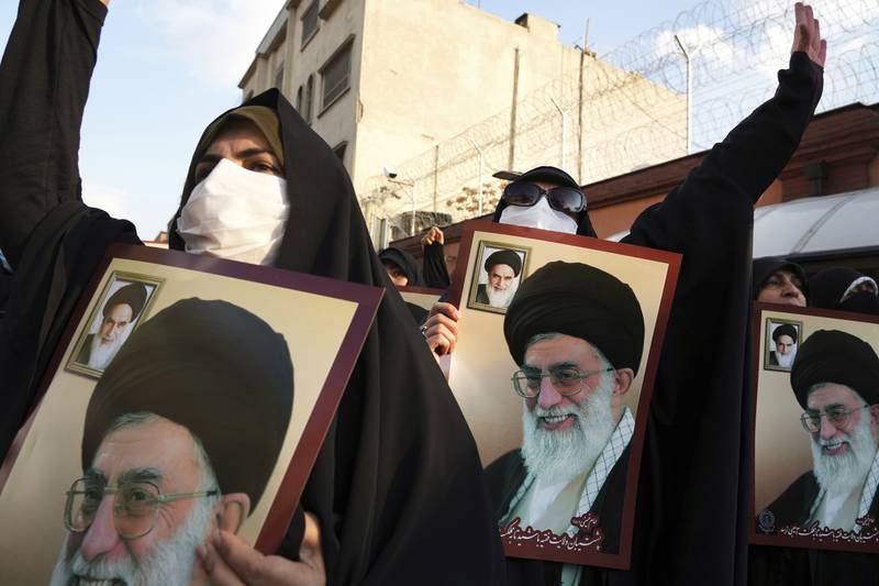 Iranian demonstrators hold posters of supreme leader Ayatollah Ali Khamenei while protesting in front of the French embassy in Tehran on Sunday against offensive caricatures in the satirical magazine Charlie Hebdo. AP