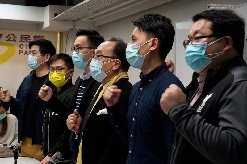 Pro-democratic party members shout slogans in response to the mass arrests during a press conference in Hong Kong Wednesday, Jan. 6, 2021. About 50 Hong Kong pro-democracy figures were arrested by police on Wednesday under a national security law, following their involvement in an unofficial primary election last year held to increase their chances of controlling the legislature, according to local media reports. (AP Photo/Vincent Yu)