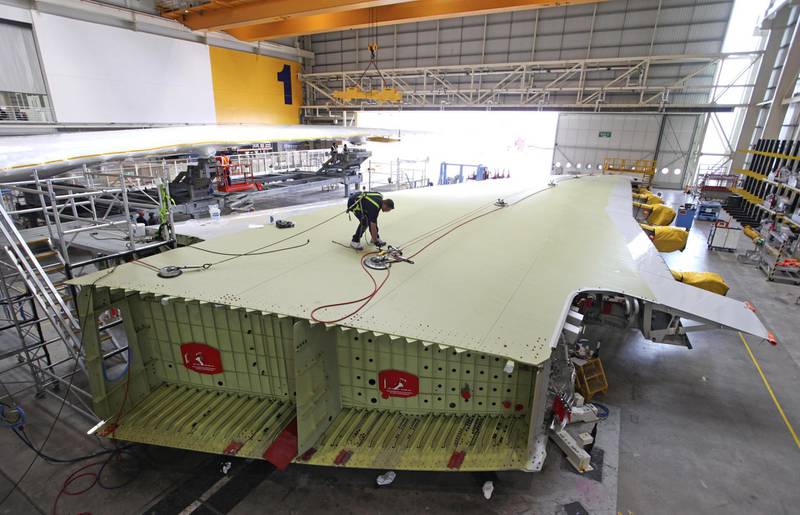 An employee inspects the surface of an Airbus A380 wing during production at the Airbus SAS factory in Broughton, UK. Bloomberg
