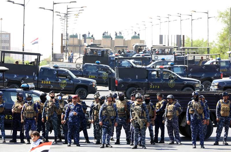 Security forces block a road as anti-government protesters try to enter the Green Zone of Baghdad. EPA 