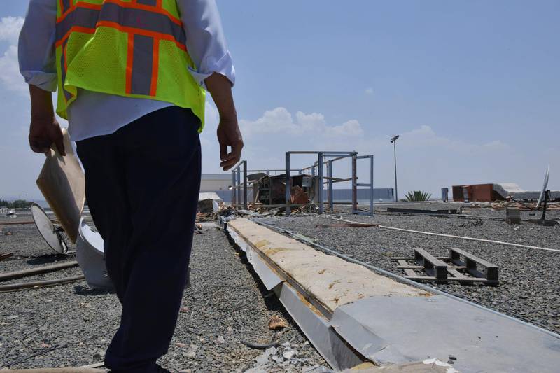 A worker fixing the damage at Abha airport.  AFP