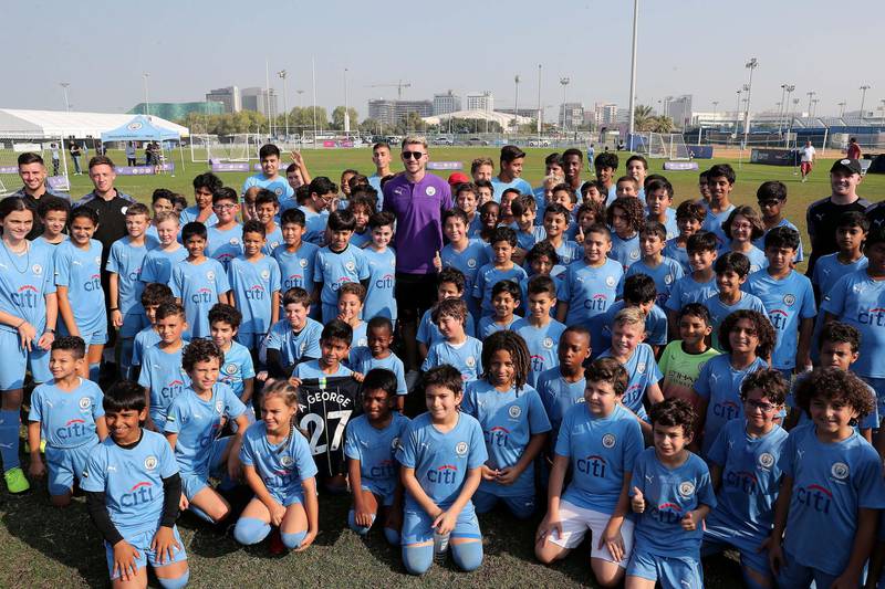 ABU DHABI, UNITED ARAB EMIRATES , Nov 30 – 2019 :- Aymeric Laporte, French footballer posing for the photo with the students of Manchester City football school Abu Dhabi at the Zayed Sports city in Abu Dhabi. ( Pawan Singh / The National )  For Sports. Story by Jon Turner 
