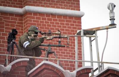 A security service officer aims his sniper rifle while securing the area in Moscow. AP Photo
