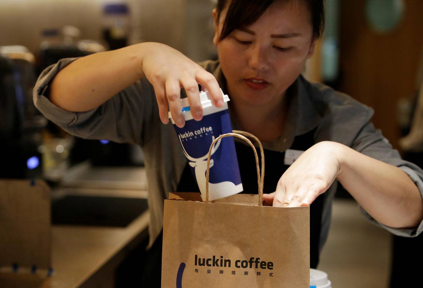 A barista packs a coffee for online sales at a Luckin Coffee store in Beijing, China July 17, 2018. Picture taken July 17, 2018. REUTERS/Jason Lee