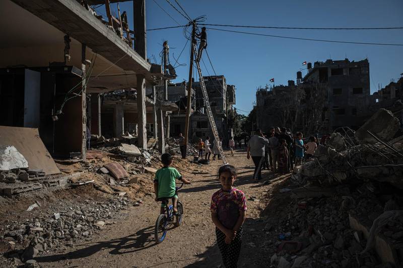A boy rides his bicycle amid the rubble of destroyed homes in Beit Hanoun, Gaza. Getty
