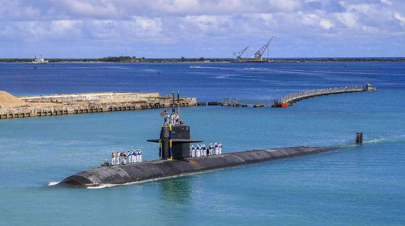 Fast attack submarine USS Oklahoma City returns to a US naval base on the Pacific island of Guam.  Australia's Prime Minister Scott Morrison has rejected Chinese criticism of his country's nuclear submarine alliance with the US.  AP
