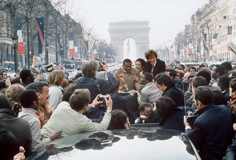 The legend is surrounded by a large crowd, in March 1971, at the Champs-Elysees in Paris. AFP