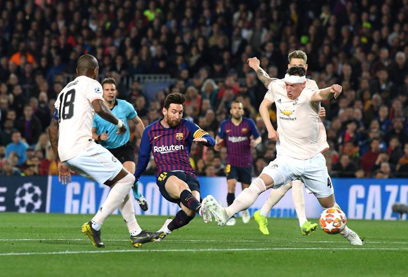 BARCELONA, SPAIN - APRIL 16:  Lionel Messi of Barcelona scores his team's second goal as Phil Jones of Manchester United tries to challenge  during the UEFA Champions League Quarter Final second leg match between FC Barcelona and Manchester United at Camp Nou on April 16, 2019 in Barcelona, Spain. (Photo by David Ramos/Getty Images)