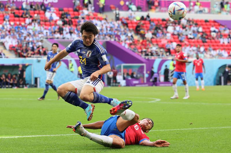 Japan midfielder Yuki Soma vaults over the outstretched leg of Costa Rica's Oscar Duarte as the game heats up. AFP