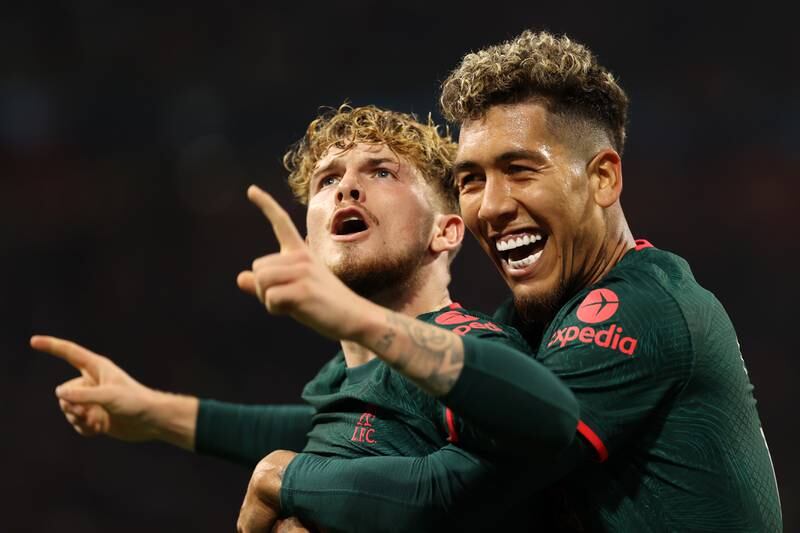 Liverpool's Harvey Elliott celebrates with Roberto Firmino after scoring the third goal in the 3-0 Champions League win against Ajax at Johan Cruyff Arena on October 26, 2022. Getty