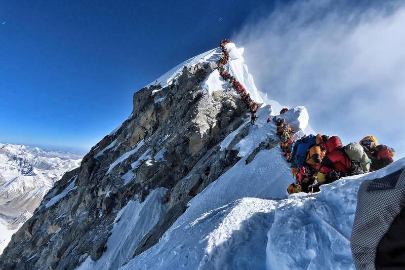 This handout photo taken on May 22, 2019 and released by climber Nirmal Purja's Project Possible expedition shows heavy traffic of mountain climbers lining up to stand at the summit of Mount Everest. - Many teams had to line up for hours on May 22 to reach the summit, risking frostbites and altitude sickness, as a rush of climbers marked one of the busiest days on the world's highest mountain. (Photo by Handout / Project Possible / AFP) / RESTRICTED TO EDITORIAL USE - MANDATORY CREDIT "AFP PHOTO / PROJECT POSSIBLE" - NO MARKETING NO ADVERTISING CAMPAIGNS - DISTRIBUTED AS A SERVICE TO CLIENTS ---