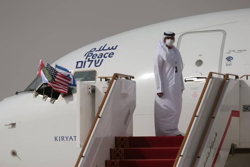 A UAE official waits for Israeli and US delegates to disembark the Israeli flag carrier El Al's airliner after landing at Abu Dhabi International Airport. Reuters