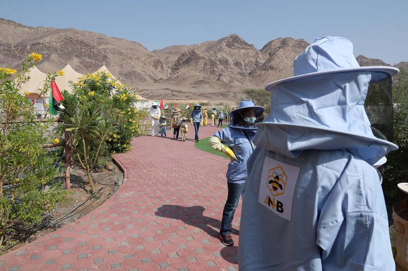DUBAI, UNITED ARAB EMIRATES , November 7 – 2020 :- Visitors wearing protective beekeeping suits and face shields during the tour at the Hatta honey bee garden at the Hatta in Dubai. The ticket price of honey bee garden tour is 50 AED per person.  (Pawan Singh / The National) For News/Online/Instagram/Big Picture. Story by Nick Webster
