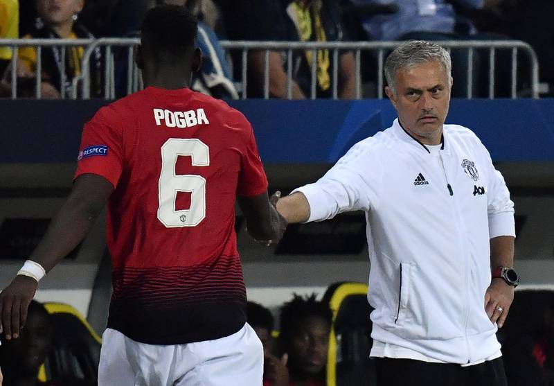 Manchester United's French midfielder Paul Pogba (L) shakes hands with Manchester United's Portuguese manager Jose Mourinho after his substitution during the UEFA Champions League group H football match between Young Boys and Manchester United at The Stade de Suisse in Bern on September 19, 2018. (Photo by Alain GROSCLAUDE / AFP)