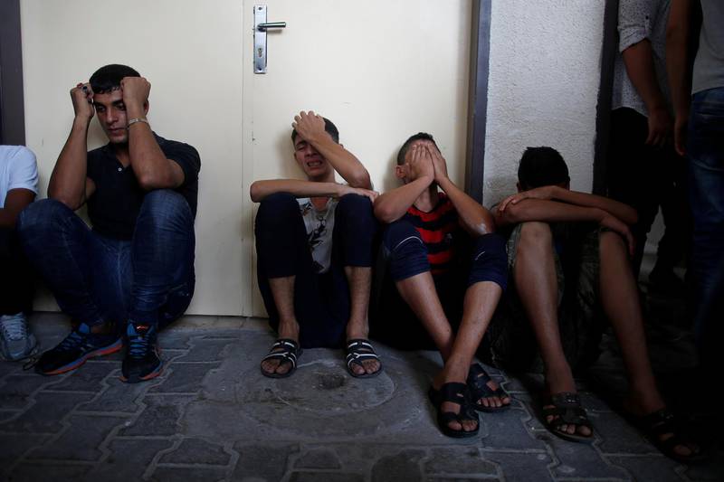 Relatives of Palestinian gunmen who were killed by Israeli forces as they tried to cross the Gaza border, react at a hospital in the northern Gaza Strip August 18, 2019. REUTERS/Mohammed Salem