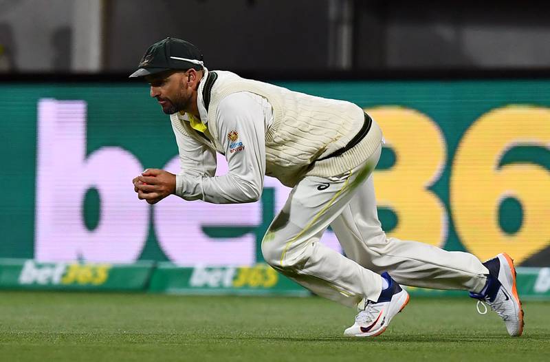 Australia's Nathan Lyon takes a catch to dismiss England batsman Ben Stokes for five. AFP