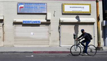 Closed shopfronts in what would be a normally busy fashion district in Los Angeles, California. The latest nonfarm payrolls report confirmed that 20.5 million Americans were out of work with the overall unemployment rate coming in at 14.7 per cent. AFP