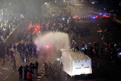 Thousands of protesters clash with the police as they block a highway in Tel Aviv. AFP