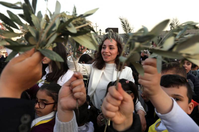 Iraqi Christians gather to celebrate Palm Sunday at the St.  Elijah church in Arbil, the capital of the autonomous Kurdish region of northern Iraq, on April 1, 2023.  (Photo by SAFIN HAMED  /  AFP)