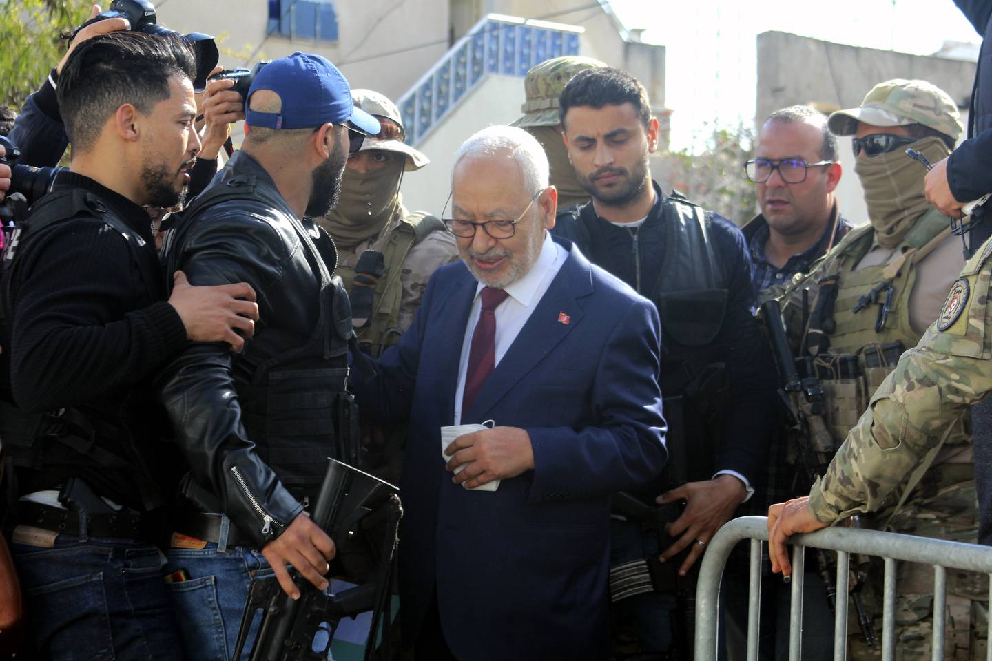 Leader of Tunisia's Islamist Ennahda party House Speaker Rached Ghannouchi, center, arrives for questioning at the judicial police headquarters in Tunis, Tunisia, Friday, April 1, 2022.  (AP Photo / Hassene Dridi)