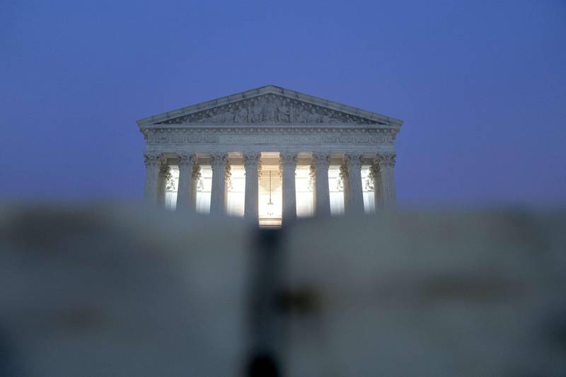 WASHINGTON, DC - OCTOBER 20: The Supreme Court stands in the early morning on October 20, 2020 in Washington, DC. The Supreme Court ruled on Monday that election officials in the state of Pennsylvania are allowed to count absentee ballots received after Election Day, as long as they are postmarked by November 3.   Stefani Reynolds/Getty Images/AFP
== FOR NEWSPAPERS, INTERNET, TELCOS & TELEVISION USE ONLY ==
