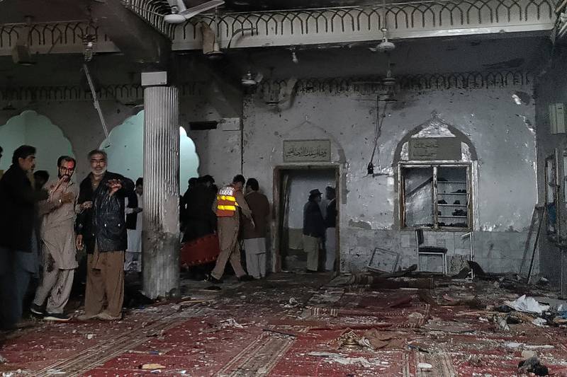 Security personnel inspect a mosque after a bomb blast in Peshawar, north-west Pakistan, on Friday, March 4. The explosion killed at least 30 people and wounded 56. AFP