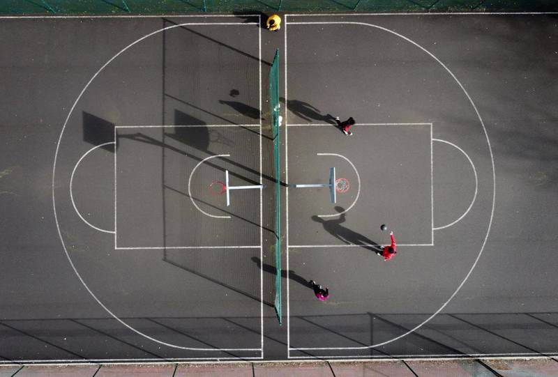 People play basketball on courts in Leazes Park, ahead of the lifting of national restrictions at the end of the month, in Newcastle. Reuters