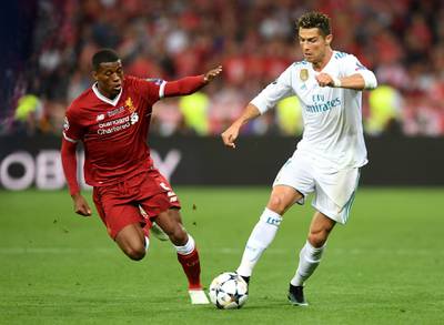 Real Madrid's Cristiano Ronaldo evades Liverpool's Georginio Wijnaldum. Michael Regan / Getty Images