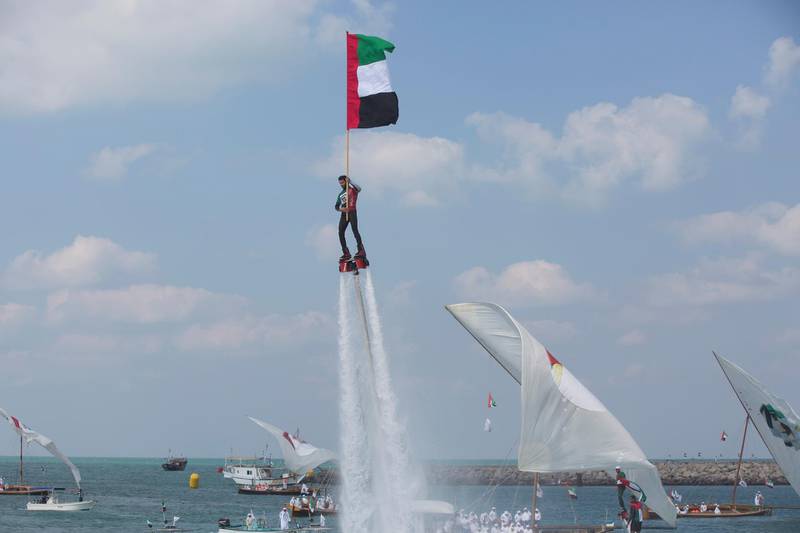 ABU DHABI, UNITED ARAB EMIRATES -  December 02, 2014: An aquatic jet pack performance during a flag raising ceremony in celebration of the UAE’s 43rd National Day, at the Breakwater in Abu Dhabi.( Ryan Carter / Crown Prince Court - Abu Dhabi )