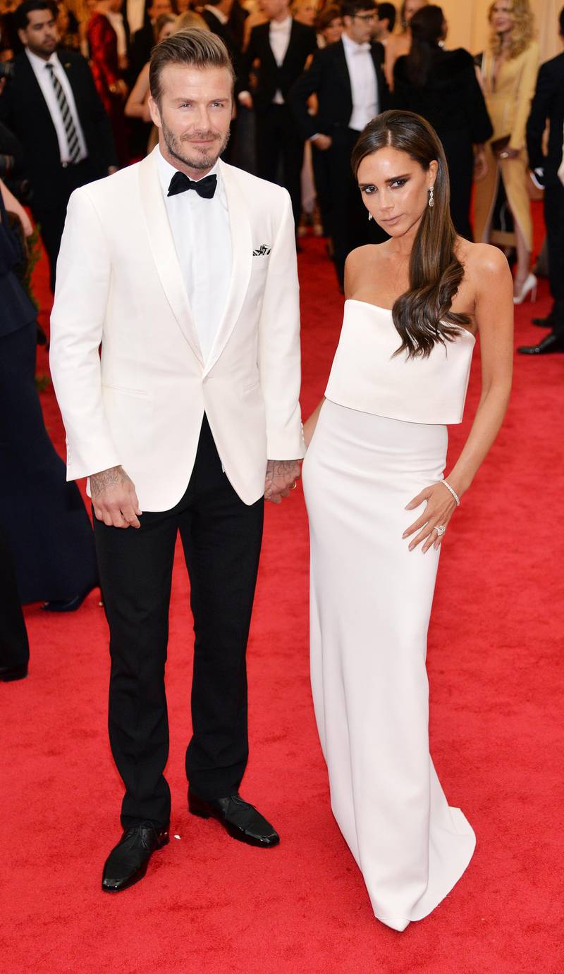epa04192900 British soccer star David Beckham (L) and wife Victoria Beckham (R) arrive for the 2014 Anna Wintour Costume Center Gala held at the New York Metropolitan Museum of Art in New York, New York, USA, 05 May 2014. The Costume Institute's new Anna Wintour Costume Center opens on 08 May with the exhibition 'Charles James: Beyond Fashion.'  EPA/JUSTIN LANE