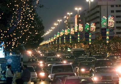 Cars are bumper-to-bumper on a lavishly decorated Dubai street in March 2000 on the third day of the month-long annual Dubai Shopping Festival. AFP