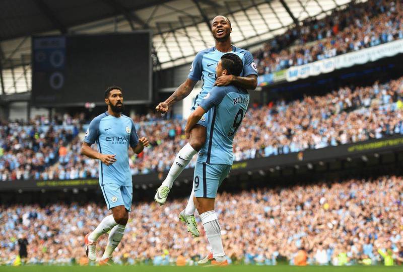 Raheem Sterling celebrates with teammates. Gareth Copley / Getty Images