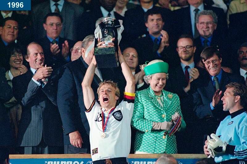 1996: Germany captain Jurgen Klinsmann lifts the trophy as the queen smiles, after the 1996 UEFA European Championships Final against Czech Republic at Wembley Stadium in London.