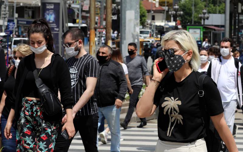 People walk past the main Kizilay Square, in Ankara, Turkey. AP Photo